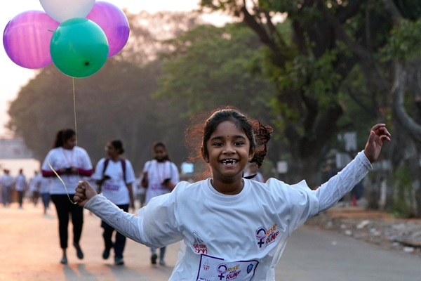 　印度安得拉州海得拉巴的城市警察组织，周一举行马拉松比赛，以庆祝3月8日国际妇女节，这次的比赛主题是“觉醒起跑”，一名女孩在马拉松比赛中带着气球奔跑。（美联社）