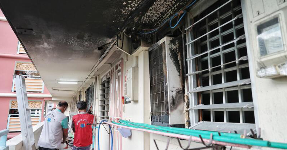 火患涉及一台旧式冷气机（窗口处），事发后走廊天花板明显熏黑。