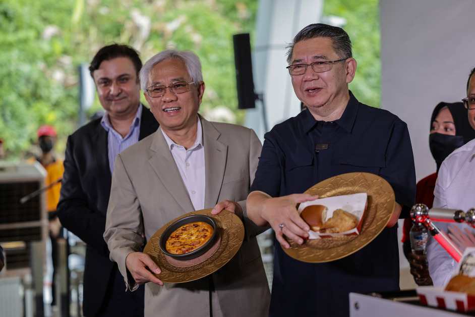 沙拉胡丁（右起）和QSR品牌（大马）控股公司主席丹斯里嘉马鲁丁展示套餐。