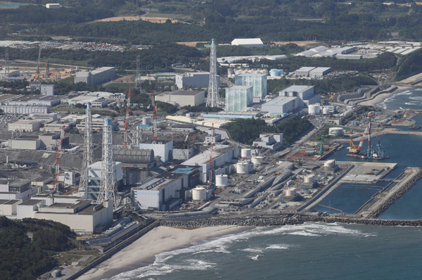 TOPSHOT - This aerial picture shows TEPCO's crippled Fukushima Daiichi Nuclear Power Plant in Okuma, Fukushima prefecture on August 24, 2023. Japan began releasing wastewater from the crippled Fukushima nuclear plant into the Pacific Ocean on August 24 despite angry opposition from China and local fishermen. (Photo by JIJI Press / AFP) / Japan OUT