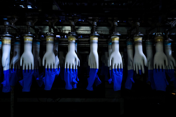 Latex gloves on hand-shaped molds move along an automated production line at a Top Glove Corp. factory in Setia Alam, Selangor, Malaysia, on Tuesday, Feb. 18, 2020. The world biggest glovemaker got a vote of confidence from investors in the credit market, as the coronavirus fuels demand for the Malaysian company rubber products. The World Health Organization is taking an unprecedented step of negotiating directly with suppliers to improve access to gloves, face masks and other forms of protective equipment. Photographer: Samsul Said/Bloomberg