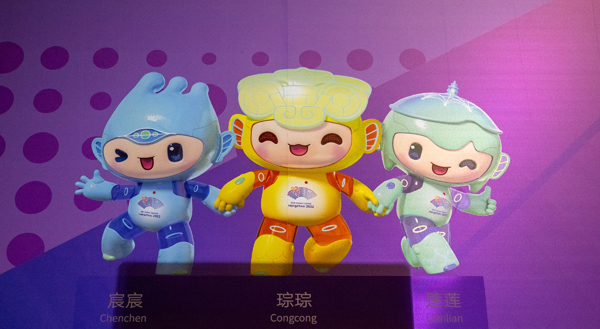 (L-R) This illustration picture taken from an exit of a subway station shows a poster of the 2022 Asian Games official mascots Chenchen, Congcong and Lianlian, in Hangzhou of China's eastern Zhejiang province on September 19, 2023. (Photo by Philip FONG / AFP)