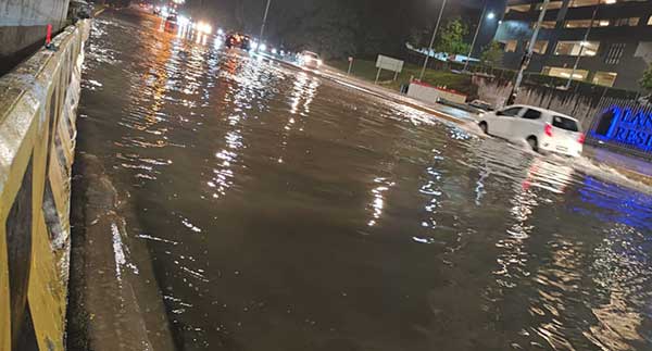 当地在大雨后水位迅速上涨，交通工具被迫涉水而行。

