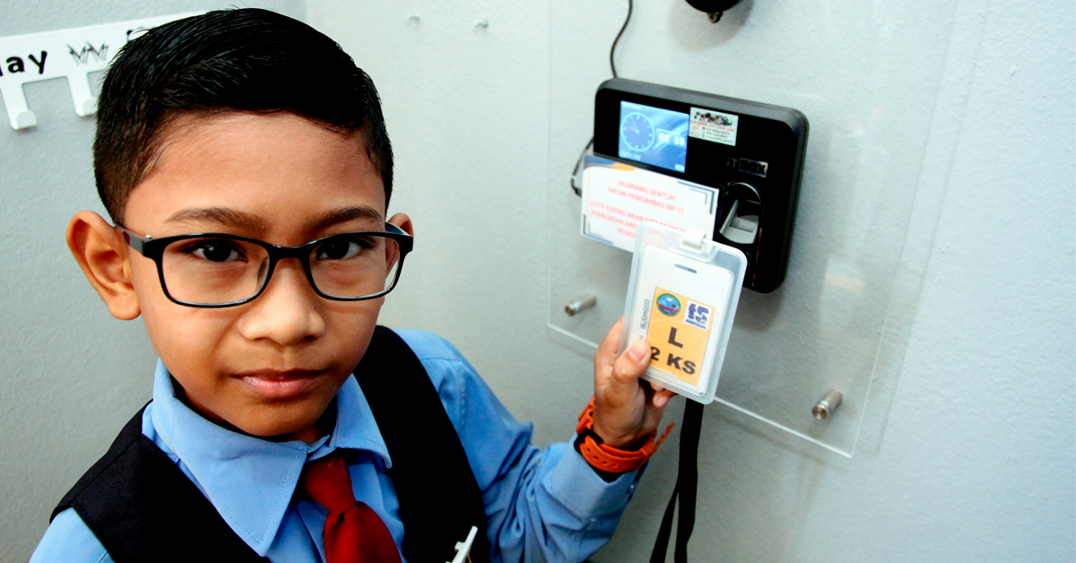 东兴港阿逸依淡拉布国小9岁的三年级学生慕哈末福甘，向“马新社”记者示范，如何使用无线射频识别扫描器上厕所。