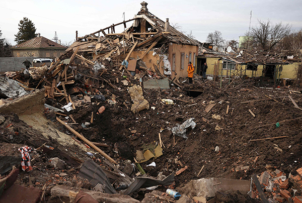 周四在乌克兰哈尔科夫地区楚胡伊夫，一名居民正在查看遭俄罗斯导弹袭击后的所形成的大地坑。（
法新社）