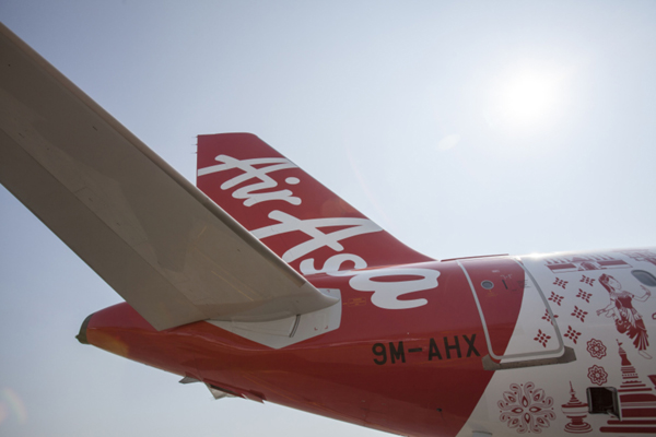 An Airbus Group NV A320 aircraft operated by AirAsia Bhd. stands on the tarmac before its unveiling at the Langkawi International Maritime and Aerospace Exhibition in Langkawi, Malaysia, on Wednesday, March 18, 2015. AirAsia, Asia's largest budget carrier, is optimistic about launching an airline in Japan next year as the tourism market is 