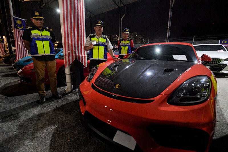 莫哈末吉菲里（中）巡查其中一辆被充公的豪车。左起为哈密迪阿当和阿兹林波汉。
