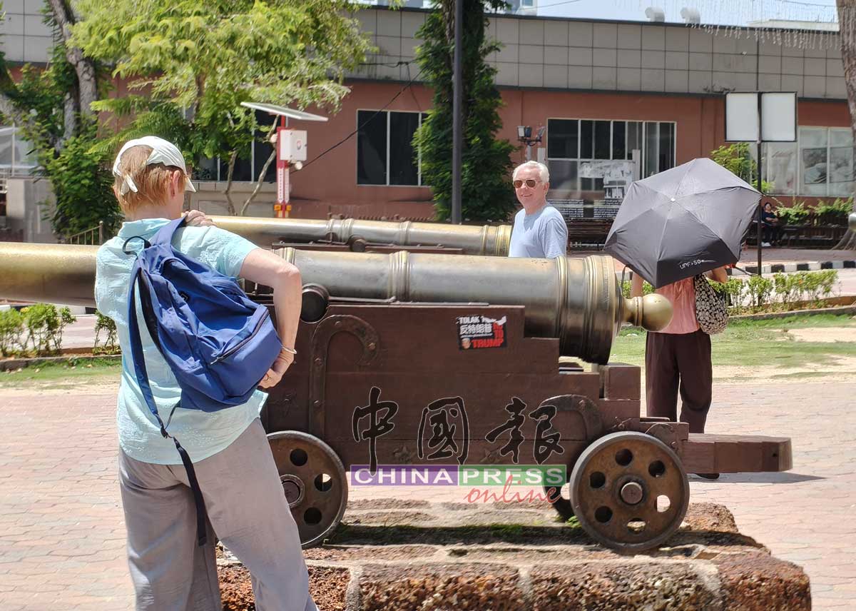 张贴印有反特朗普肖像的贴纸，引起外国游客关注。