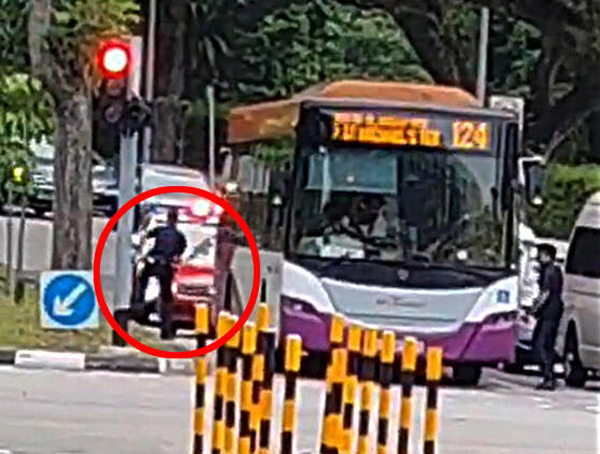 警员示意红色轿车司机下车,却险些被撞。(取自网络)