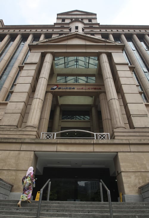A visitor arrives at the Bursa Malaysia Bhd. headquarters in Kuala Lumpur, Malaysia, on Tuesday, Sept. 18, 2012. The Malaysian and Singaporean stock exchanges are seeking to attract individual investors and bolster volumes by offering cross-border trading, the first step in creating a Southeast Asian platform. Photographer: Goh Seng Chong/Bloomberg